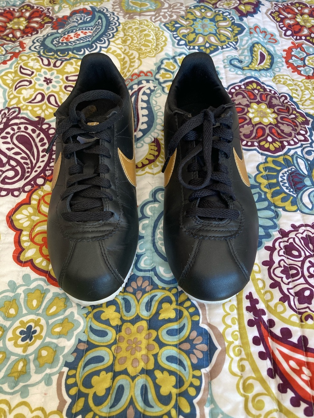 Nike Black Sneakers with Gold Swoosh Accent